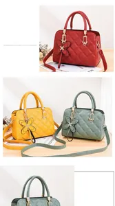 Detailed close-up of quilted leather handbags with metal buckles and butterfly charms