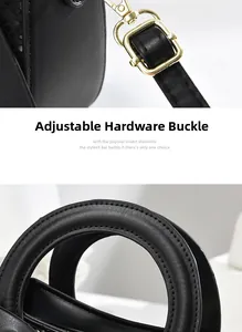 Détails d'un sac à main en cuir noir avec boucles dorées et poignées à coutures renforcées