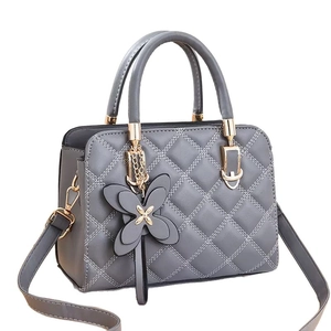 Deep grey quilted leather handbag for women featuring a 3D butterfly charm and gold hardware