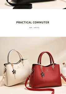 Close-up of elegant tote bag with golden hardware and chic floral decorative pendant