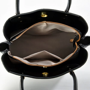 Top view of black leather tote bag showing beige herringbone lining and interior pockets