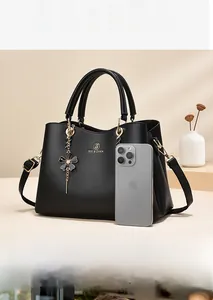 Black lychee textured PU leather handbag with gold logo and flower charm detail