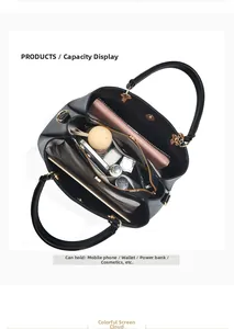 Three-layer interior of large black faux leather handbag showing spacious storage capacity