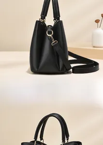 Detail view of the black handbag side profile with gold hardware and texture