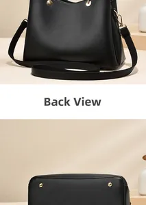 Detail view of the black tote bag back and flat base with protective gold studs