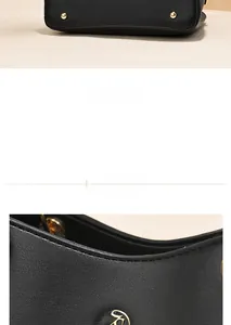 Close-up of black leather handbag featuring golden bottom studs and round metal logo detail