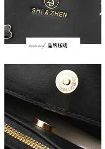 Macro detail of litchi grain leather bag with gold-plated logo and magnetic closure
