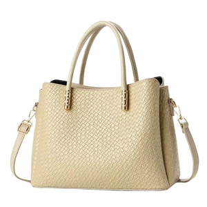 Minimalist cream textured leather tote bag with gold hardware and a long shoulder strap