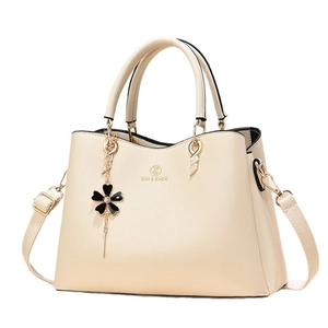 Chic cream leather handbag with gold hardware and flower charm for women