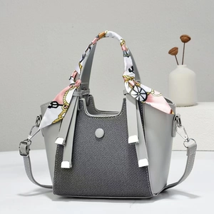 Elegant grey textured handbag with silk scarf handle and detachable shoulder strap