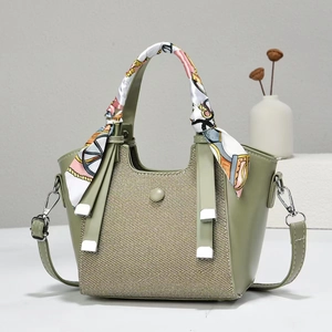 Detail of sage green vintage tote bag featuring canvas patchwork and floral scarf handle