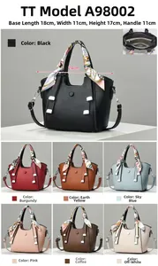 Detailed view of women's litchi leather bucket bag with dimensions 18x11x17 cm and silk scarf
