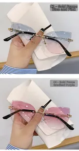 Détail de lunettes de soleil œil-de-chat sans monture avec branches dorées et verres dégradés