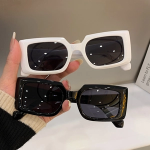 Retro square sunglasses with black and white frames and dark lenses for fashion
