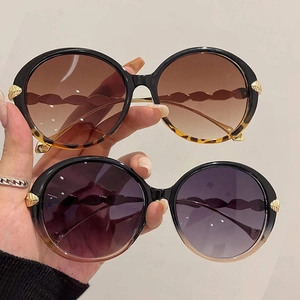 Fashionable round oversized sunglasses with gold leaf detail and gradient lenses for women