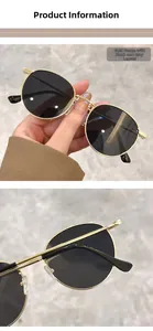 Detail view of gold metal frame sunglasses with black grey lenses and hinge mechanism
