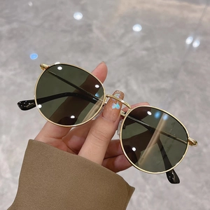 Classic small round gold metal sunglasses with dark lenses for a retro fashion look