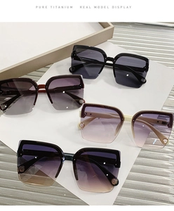 Detail view of pure titanium rimless sunglasses with gradient lenses and镂空 temple design