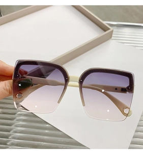 Detail of square oversized rimless sunglasses with purple gradient lenses and glitter trim