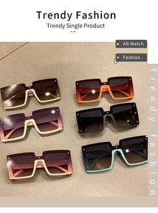 Flat lay of trendy oversized square sunglasses with gradient lenses and rivet details