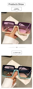 Detail of square sunglasses in beige and teal frames with chic gradient lenses
