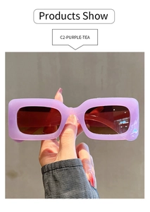 Detail of purple translucent rectangular sunglasses with brown tinted lenses