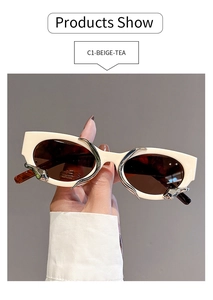 Detail view of beige frame sunglasses with tea lenses and sleek silver metal accents