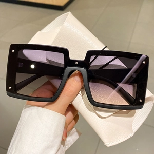 Fashionable oversized rectangular sunglasses with gradient lenses and metal rivet accents