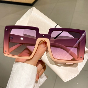 Fashionable oversized gradient pink sunglasses with rivet details and a leather case