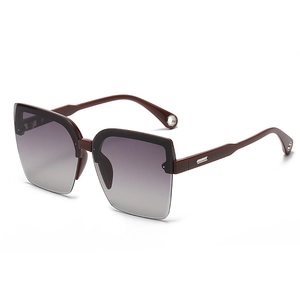 Fashionable rimless sunglasses for women with brown gradient lenses and metal hardware