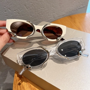 Retro cat-eye sunglasses with silver metal spike accents in white and transparent frames