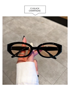 Detail of small oval sunglasses with black frames and champagne lenses, C3 model