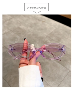 Detail view of oval sunglasses featuring a transparent purple frame and tinted lenses