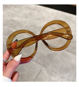 Detailed close-up of fashion round oversized amber resin frames with clear lenses