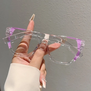 Detailed close-up of modern clear cat-eye frame glasses with stylish purple temples