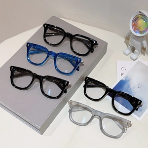 Detailed view of cat eye metal frame glasses in black, blue, and gray colors