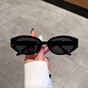 Minimalist black oval sunglasses with thick frame and dark grey lenses for a retro look