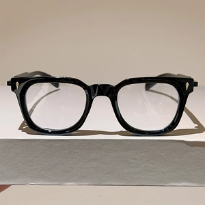 Detail of cat eye metal frames with golden arrow accents and clear anti-blue light lenses