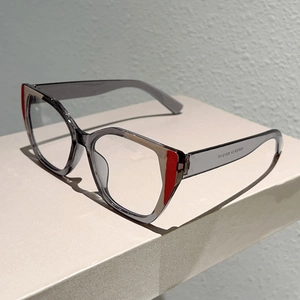 Detail of grey cat eye glasses with red accents and model KD3728 printed on the temple