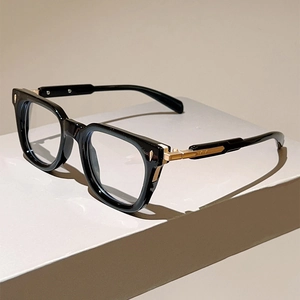 Detailed side view of cat-eye frames with golden metal accents on polished black temples