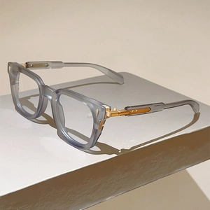 Detailed macro of cat-eye frames featuring golden V-shaped metal hinges and purple acetate