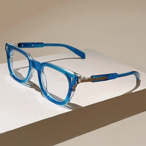Detail of transparent blue cat-eye frames with golden metal accents on temple side