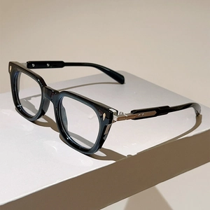 Detail of premium black cat-eye glasses frame with silver metal hinges on display