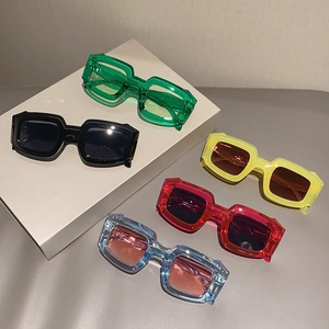Five pairs of trendy irregular candy-colored sunglasses in vibrant rectangular frames