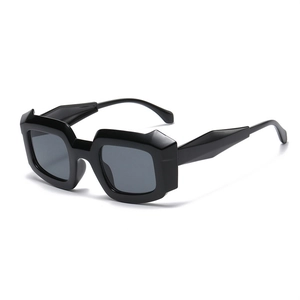 Modern black geometric thick frame sunglasses with dark grey lenses in 45-degree side view
