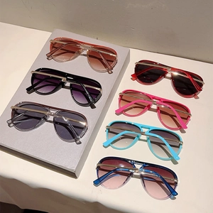 Detailed flat lay of colorful aviator sunglasses with gradient lenses and double bridge