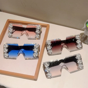 Detail of oversized rimless square sunglasses with luxury pearl and rhinestone embellishments