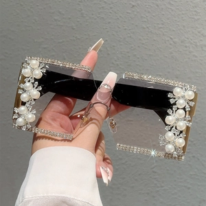 Detail of oversized rimless square sunglasses with sparkling rhinestones and white pearls