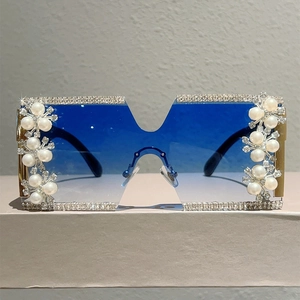 Detail of oversized rimless square sunglasses with rhinestones and pearl floral accents