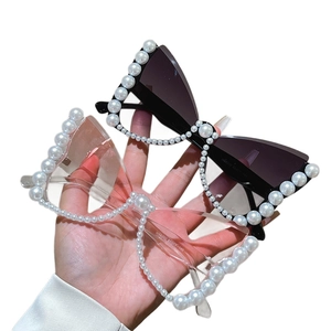 Chic cat-eye sunglasses with pearl-embellished frames and oversized butterfly design
